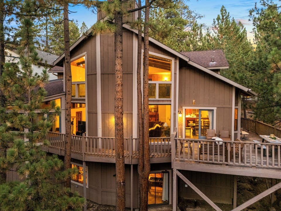 Tucked away in the pines, this cabin's warm glow and inviting decks are the perfect welcome to your getaway.