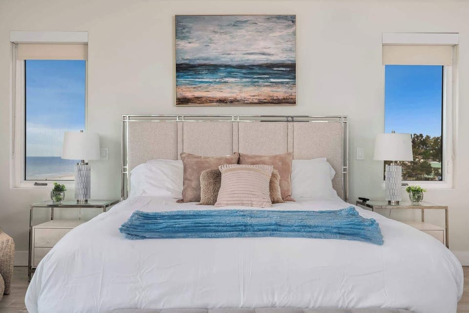 Enjoy a spacious master suite designed for comfort and style. With plush bedding and seaside artwork, it’s a peaceful escape after a day in the sun.
