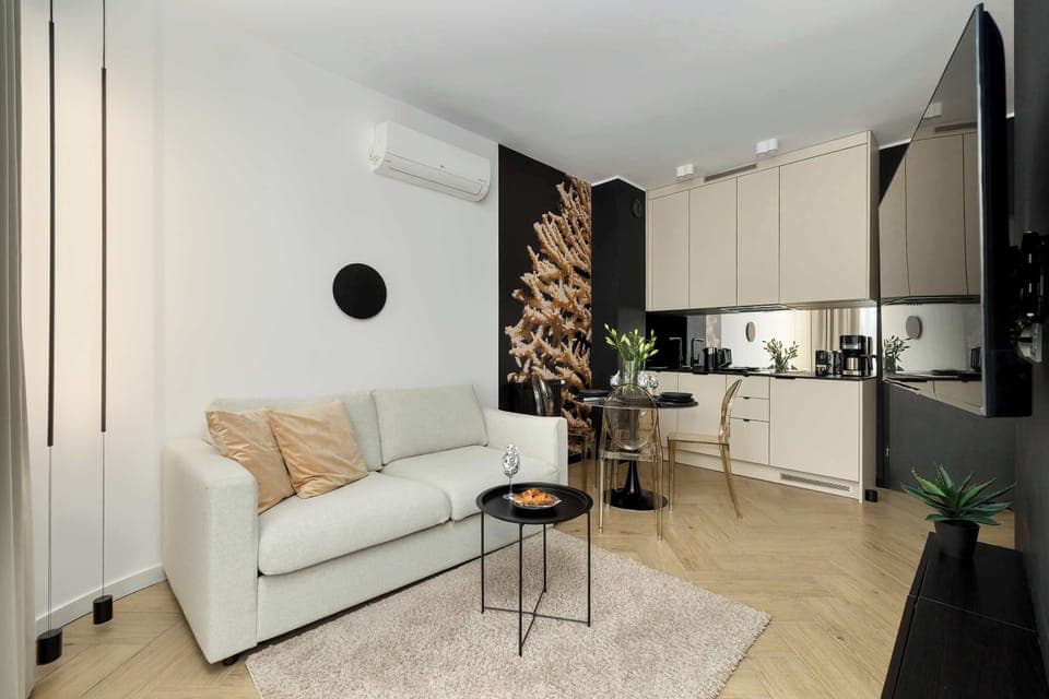 Relax in the stylish living area with a comfortable sofa and modern decor.