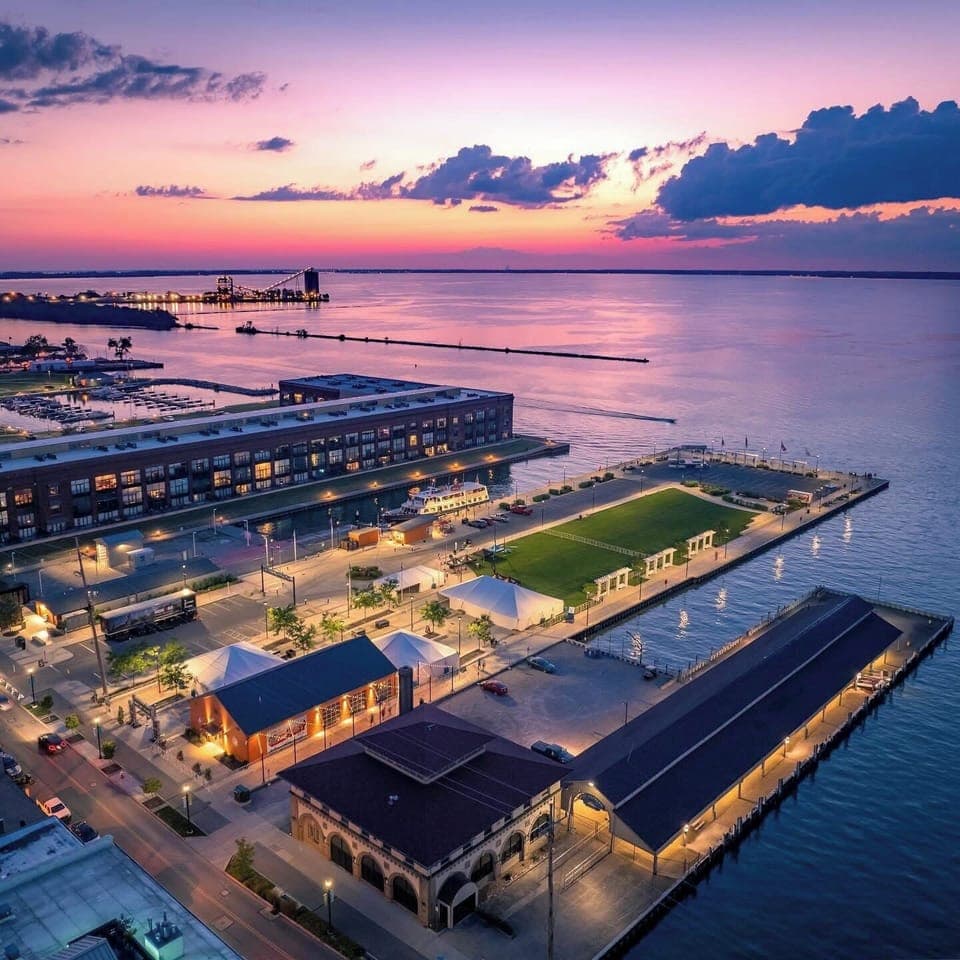 Stunning waterfront property captures twilight magic over the marina, with vibrant sunset hues painting the sky above peaceful waters.