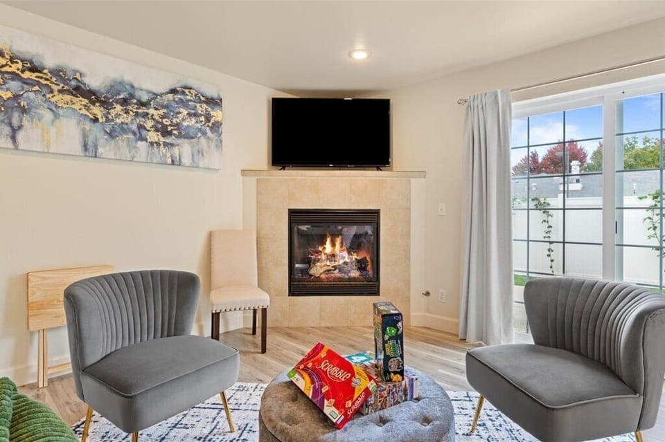 Warm and inviting living room with fireplace, board games, and comfy seating