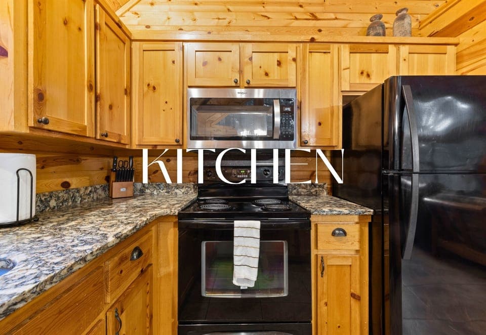 Fully equipped kitchen with granite counters and woodsy charm