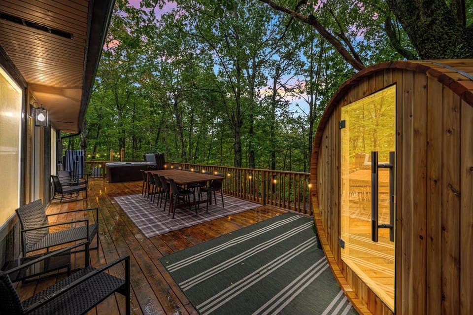 Escape to serenity with our dining space, sauna, and hot tub nestled among the trees.