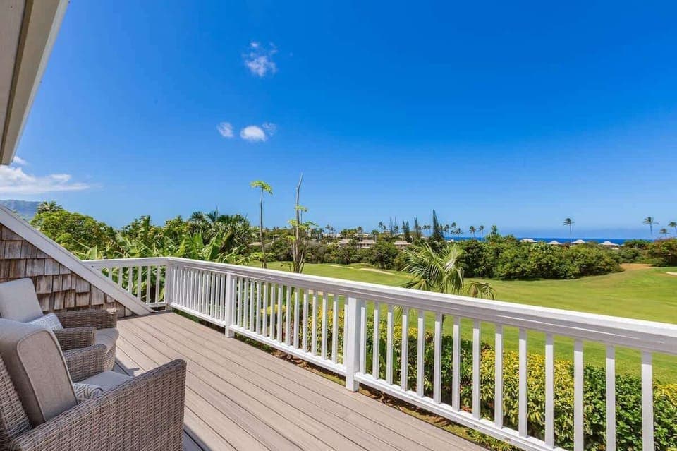 Elevate your island experience with sweeping vistas of the ocean and manicured fairways from your private deck