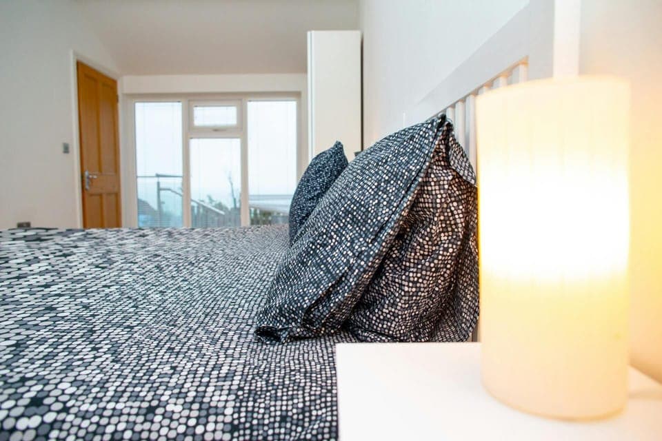 Queen size bedroom with sea views through the doors