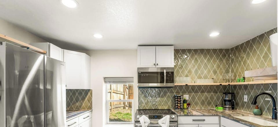 Fully stocked kitchen, with drip coffee maker (complimentary ground coffee, sugar and tea), cookware, dinnerware, and spices. Guests supply their own condiments.