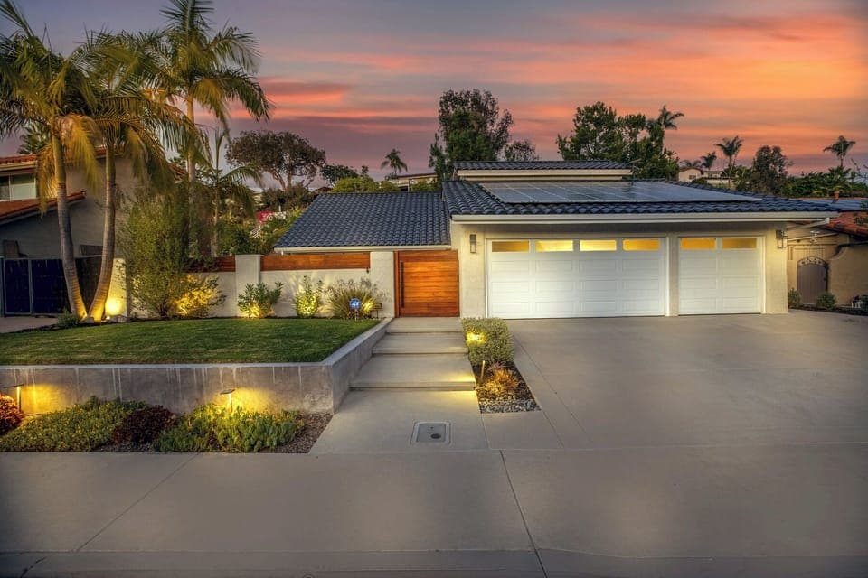 Front exterior view showing solar panels and modern architecture.