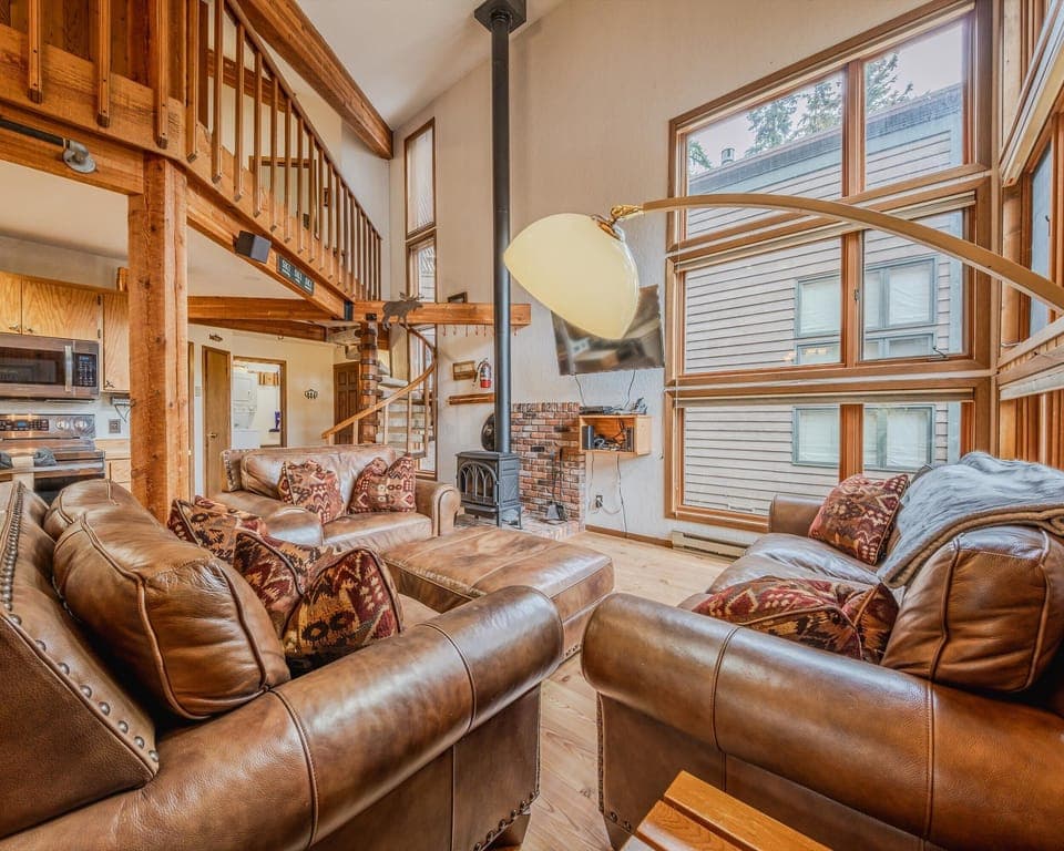 Bright open living area with leather seating and Smart TV