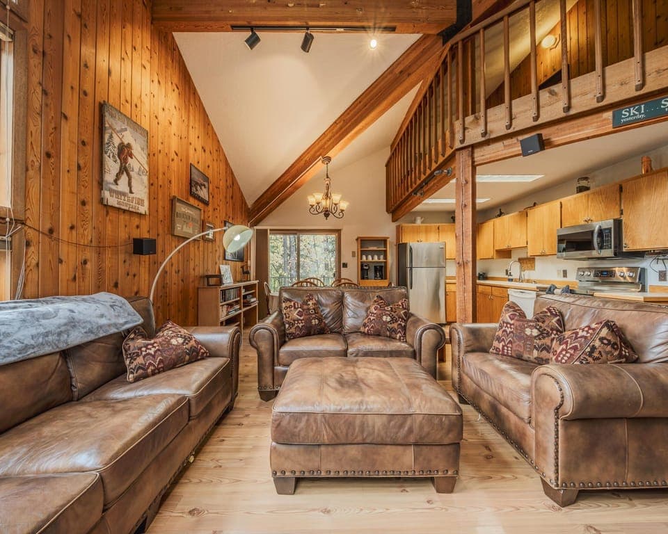 Bright open living area with leather seating and Smart TV