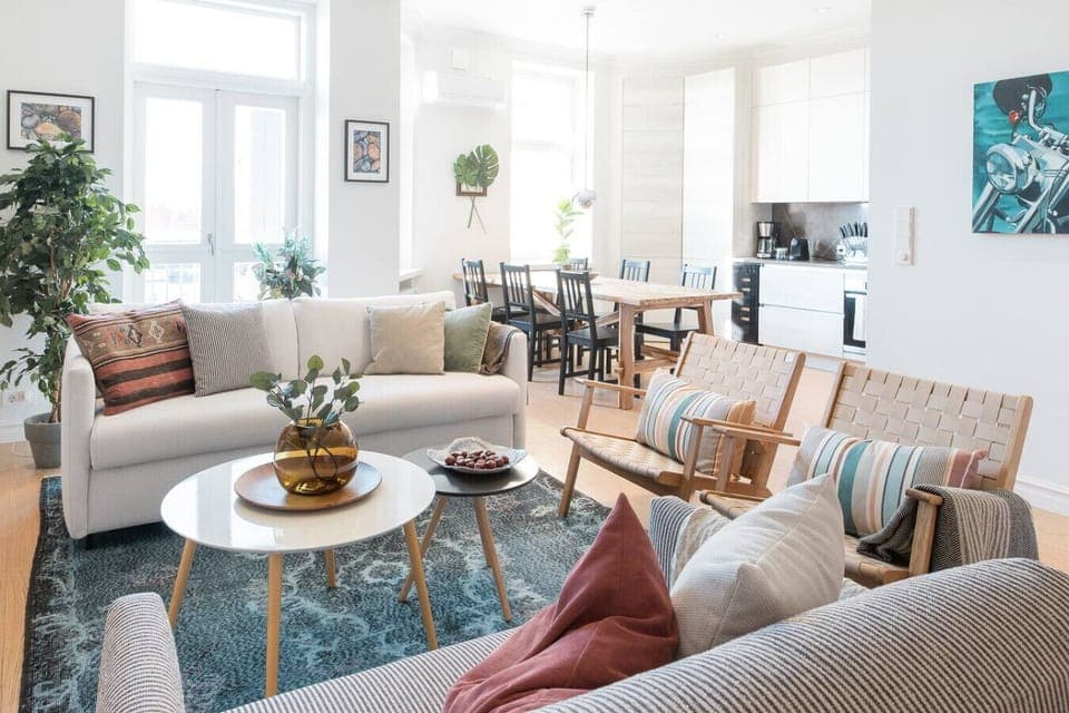 Bright and airy living space, drenched in natural light with sleek modern finishes — a perfect blend of style and comfort for your stay in Helsinki.