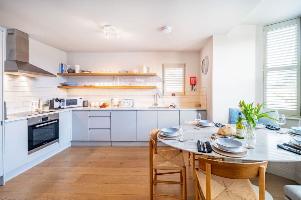 White Horses, Blakeney: Kitchen/ diner with an electric oven and induction hob, large fridge/freezer, microwave, dishwasher, washing machine, tumble dryer and coffee machine