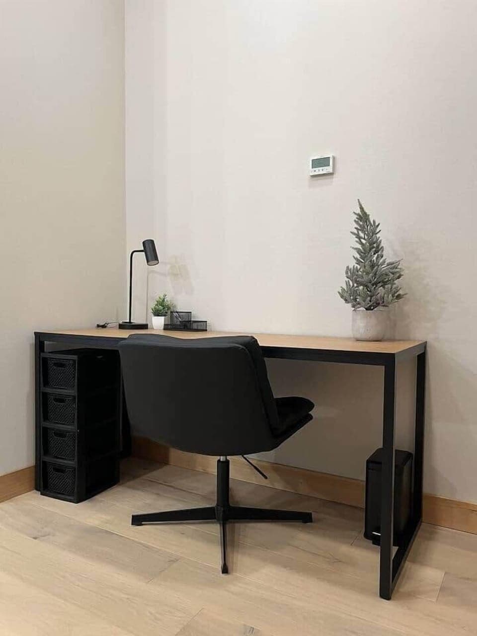 Maintain productivity during your mountain getaway with this sleek, dedicated workspace. This area is designed for the modern professional, featuring a clean wood and matte black desk and a comfortable executive-style swivel chair.
