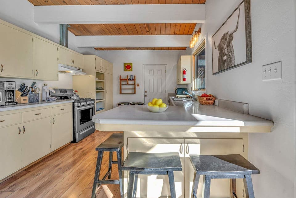 Kitchen: Smaller in size yet fully equip to cook a family meal. Authentic wood-beamed ceilings and vintage cabinetry equipped with a drip coffee maker, toaster, blender, and essential cooking utensils.