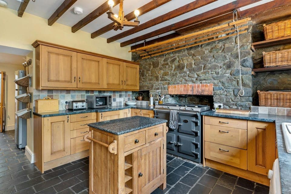 Pine wall and base units. Butchers block in centre of kitchen