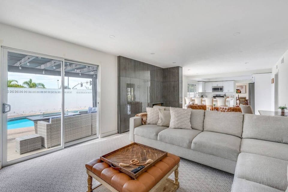 Open and airy living room with comfortable seating, Smart TV, and easy backyard access