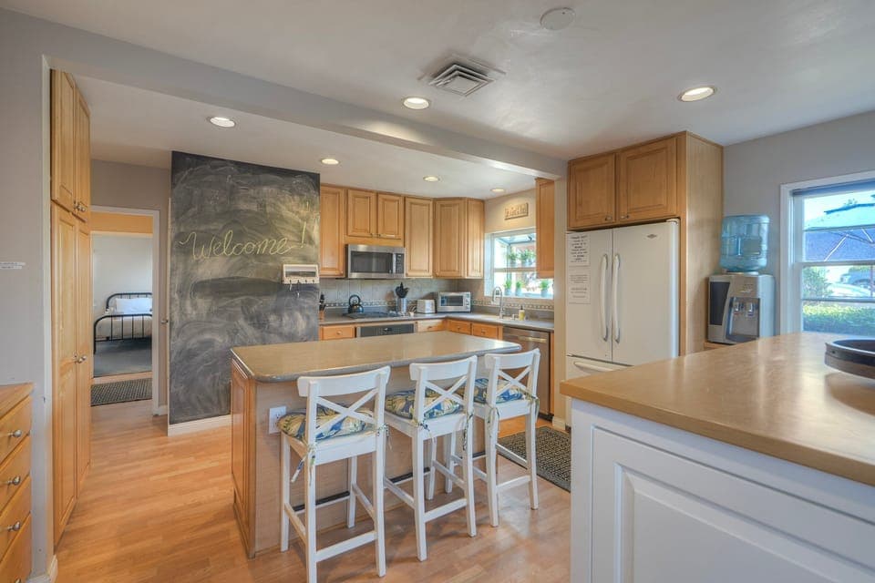 Eat-in chef's kitchen, island seating, chalkboard wall.