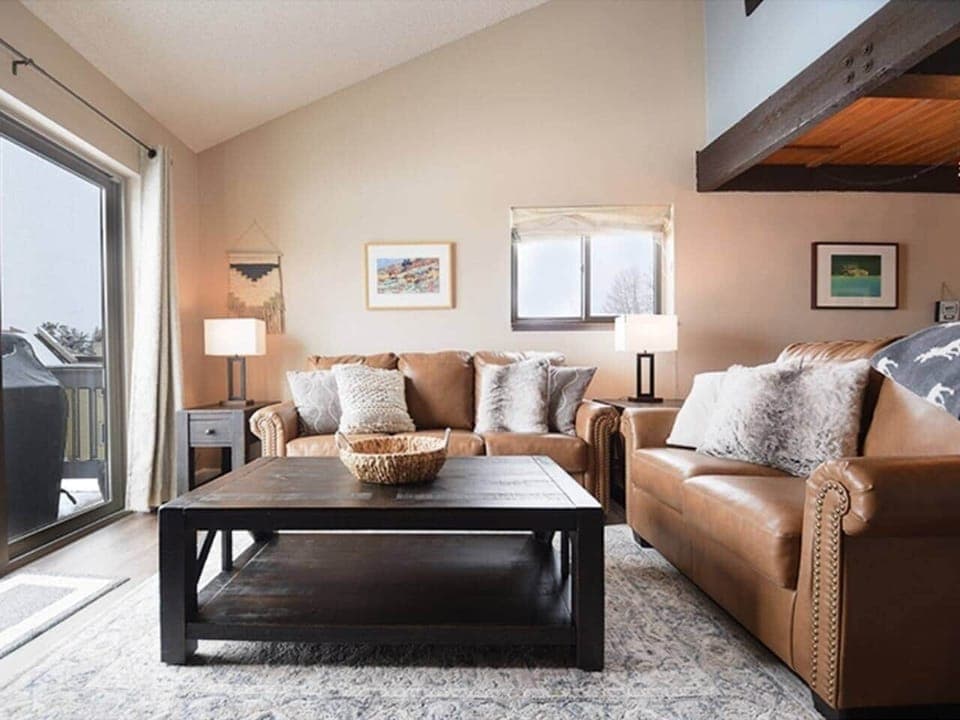 Open concept living with a woodburning fireplace and mountain views of Byers Peak, perfect for hosting, cooking, and relaxing with the whole family.