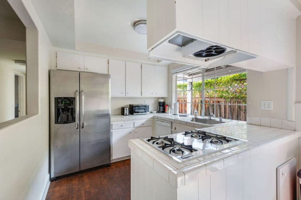 Fully equipped kitchen with stainless steel appliances and ample counter space.