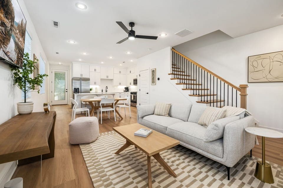 This space features plush seating, a large Smart TV, dining table for 4, and a large kitchen island with bar seating