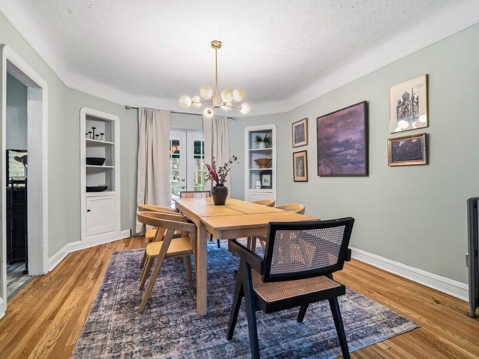 Stylish dining space w/ art-lined walls & warm lighting for memorable dinners 🍷✨🍽️