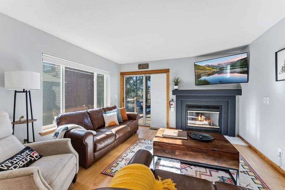 Cozy up by your crackling fireplace with plush leather seating and mountain views on the smart TV for perfect evenings.