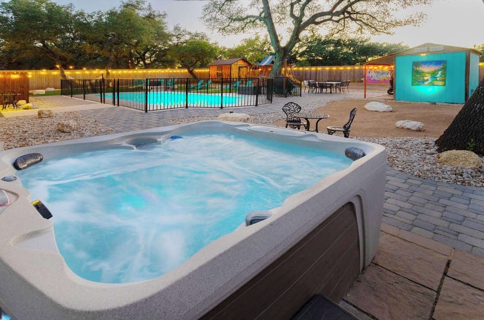 Backyard oasis with pool, hot tub, playscape