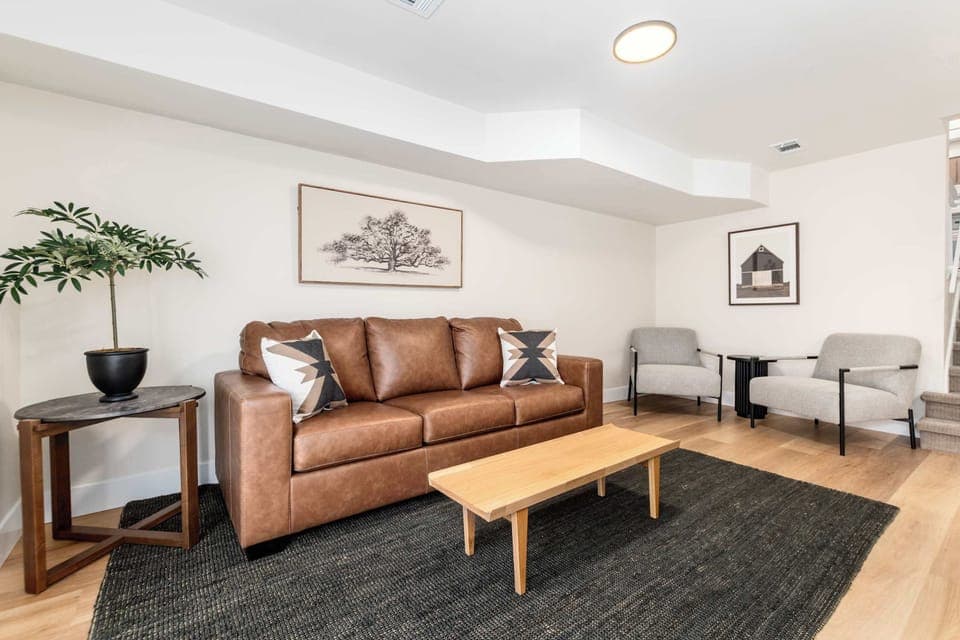 Stylish living room with sleek sofa, smart TV, and bright windows.