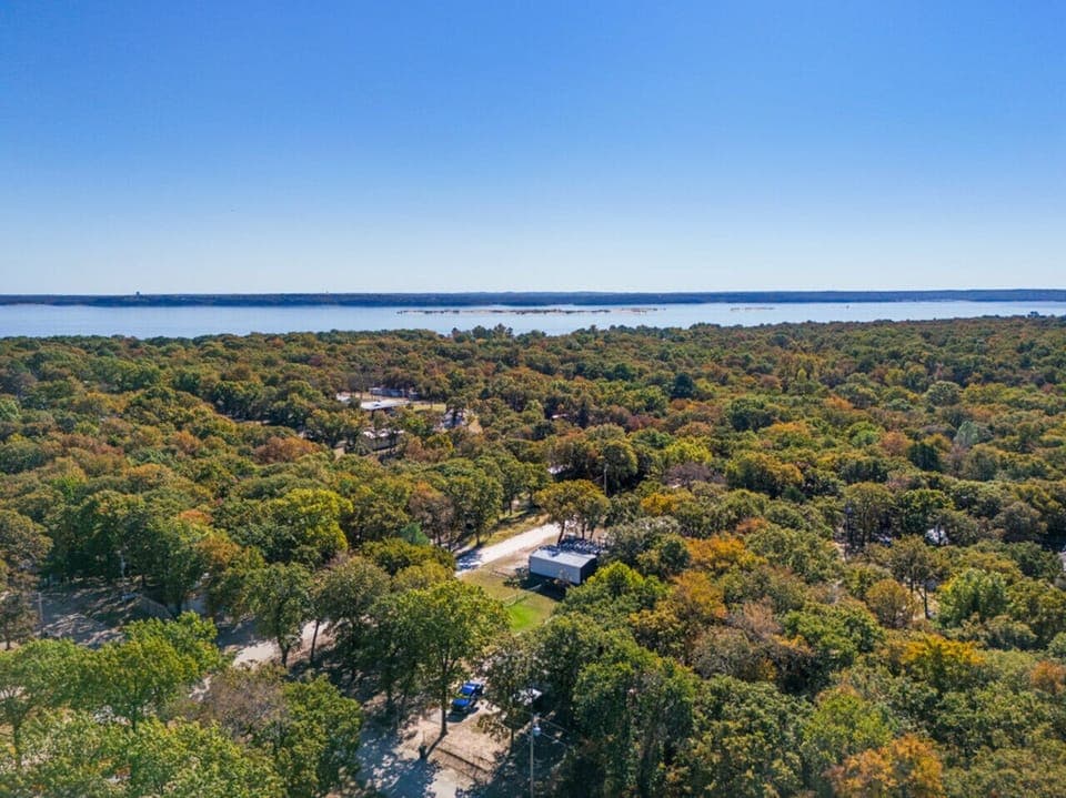 Aerial View | Serene Lakefront Surroundings | Peaceful Tree-Lined Neighborhood | Minutes from Waterfront Recreation