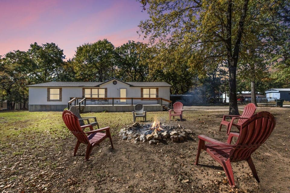 Exterior | Peaceful Wooded Setting with Fire Pit | Spacious Deck for Relaxation | Perfect for Outdoor Gatherings