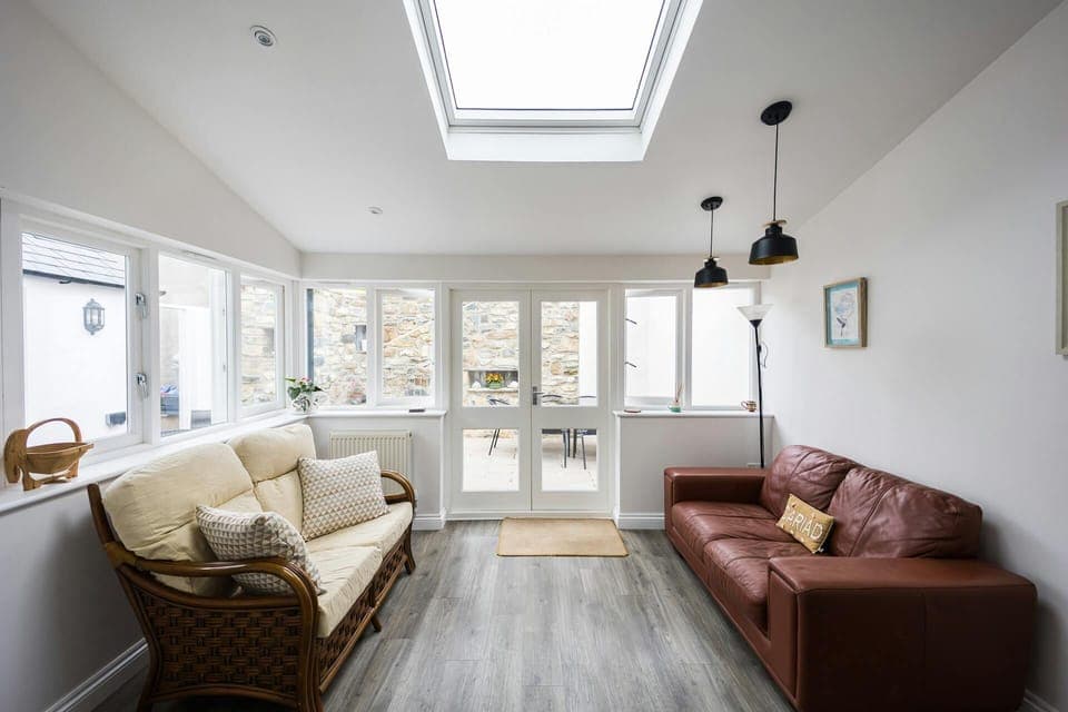 Conservatory with two large sofas and standard lamp