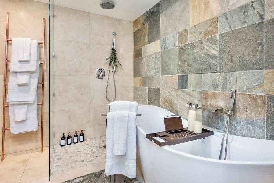 Primary bathroom with luxurious rain shower and soaking tub