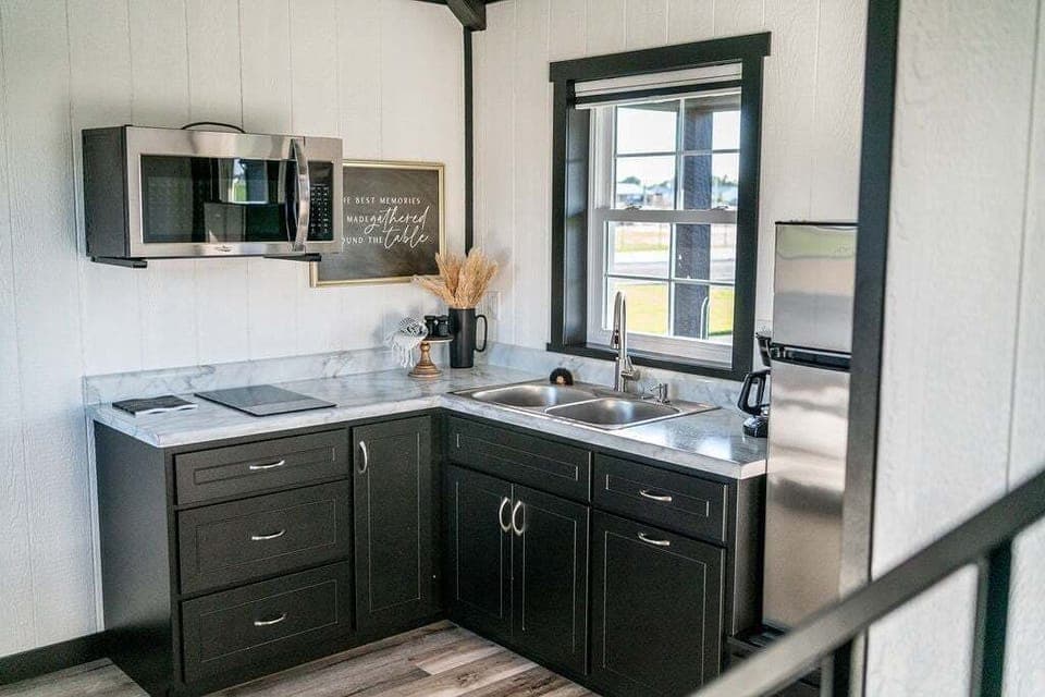 The kitchenette is equipped with a microwave, refrigerator, drip coffee maker, and hot plate.