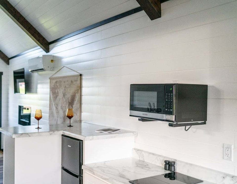 The kitchenette is equipped with a microwave, mini refrigerator, and hot plate.