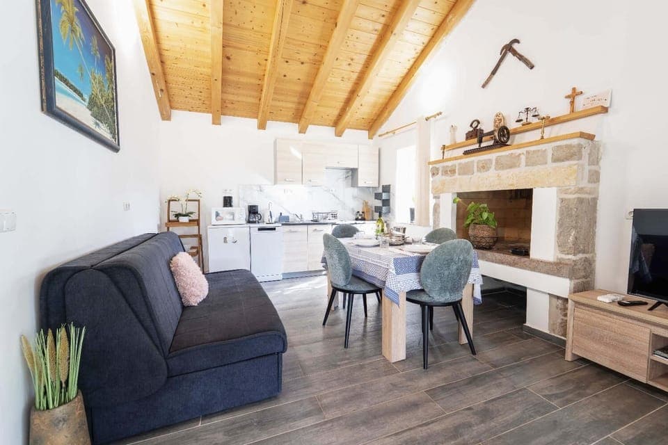 Open-plan living room with sofa, dining area, kitchen, WiFi internet, and satellite TV