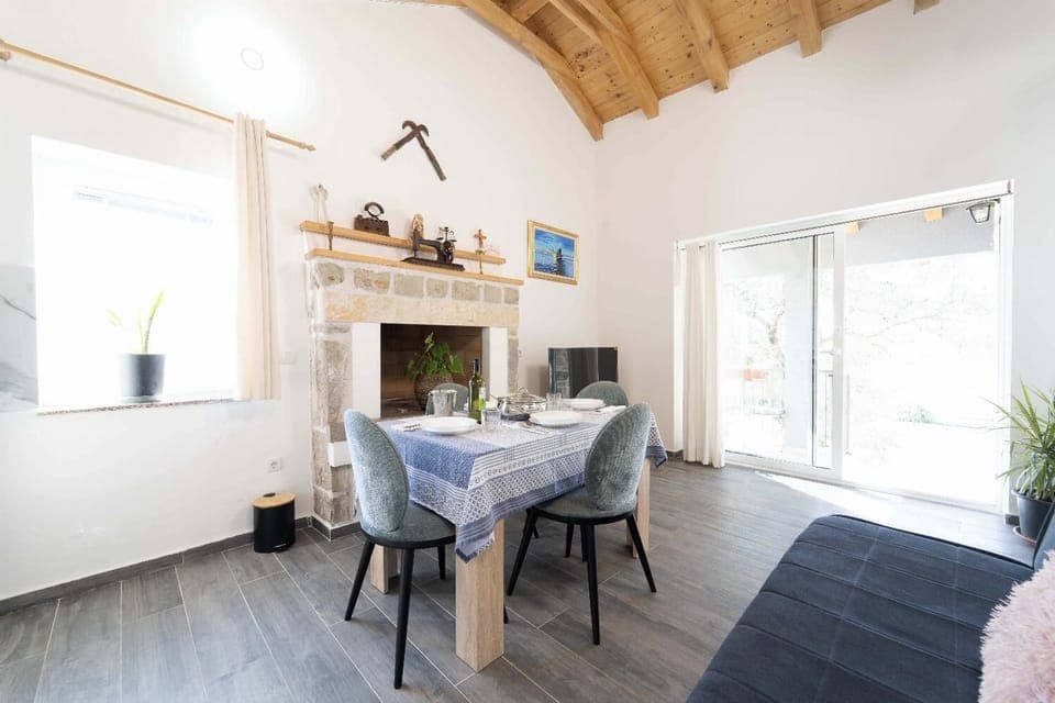 Open-plan living room with sofa, dining area, kitchen, WiFi internet, and satellite TV