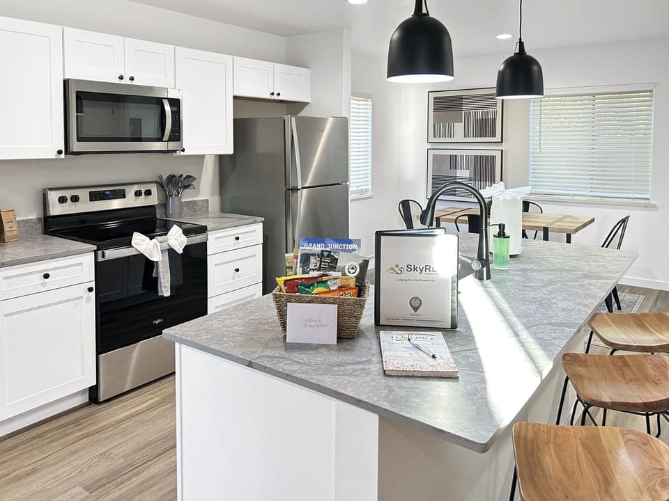 Modern kitchen with sleek marble countertops, stainless steel appliances