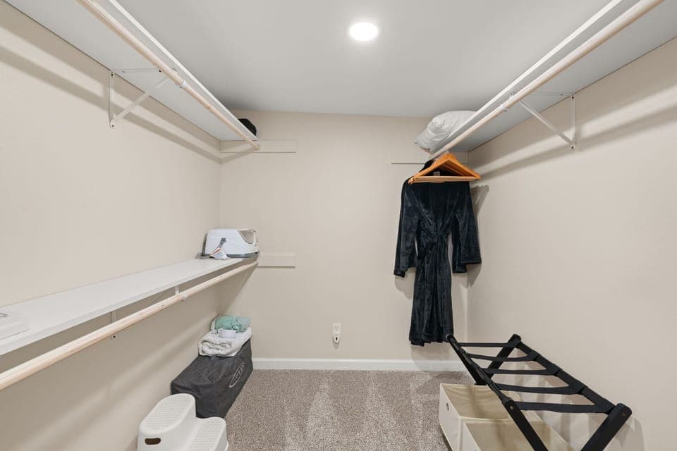 Master closet: spacious with hangers, shelves, pack-n-play, & family essentials