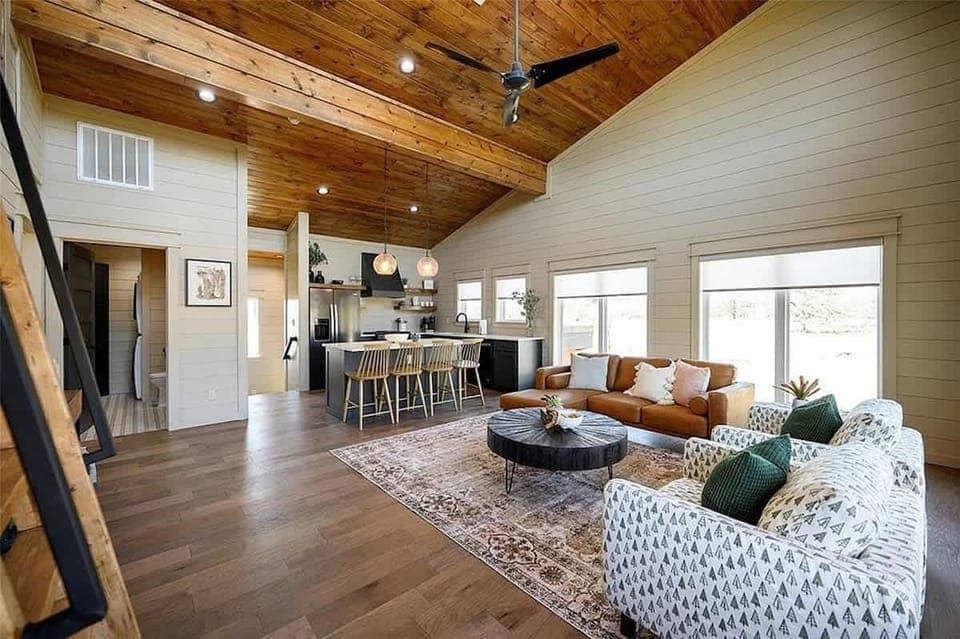 Stylish living area with wood ceilings, Smart TV and sleeper sofa