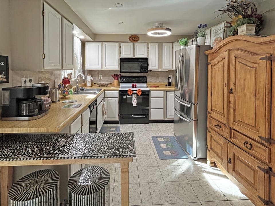 Warm wood kitchen with modern appliances and homey comfort.