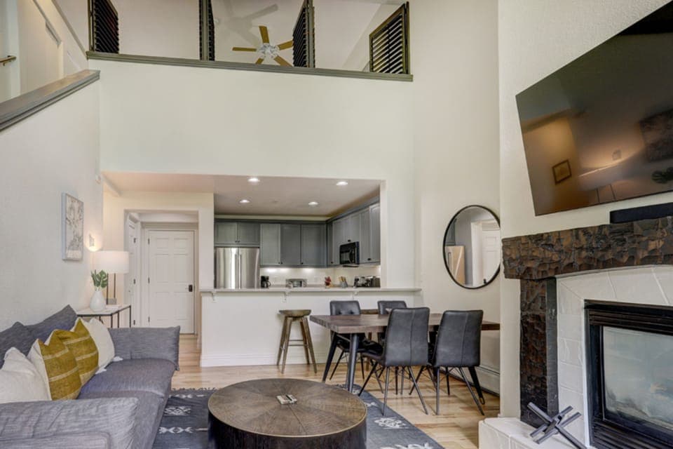 The open living and dining space pairs rustic textures with modern design, creating the perfect alpine retreat for family and friends.