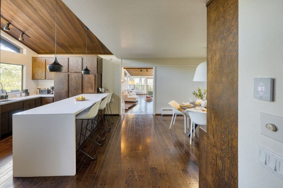 Modern kitchen with a spacious island, pendant lighting, and stunning natural light.