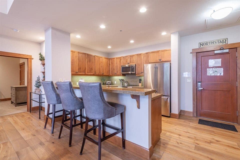 Your fully-equipped kitchen awaits with warm wood cabinetry, granite countertops, and stainless steel appliances. Pull up a barstool and savor morning coffee while planning your day's adventures.