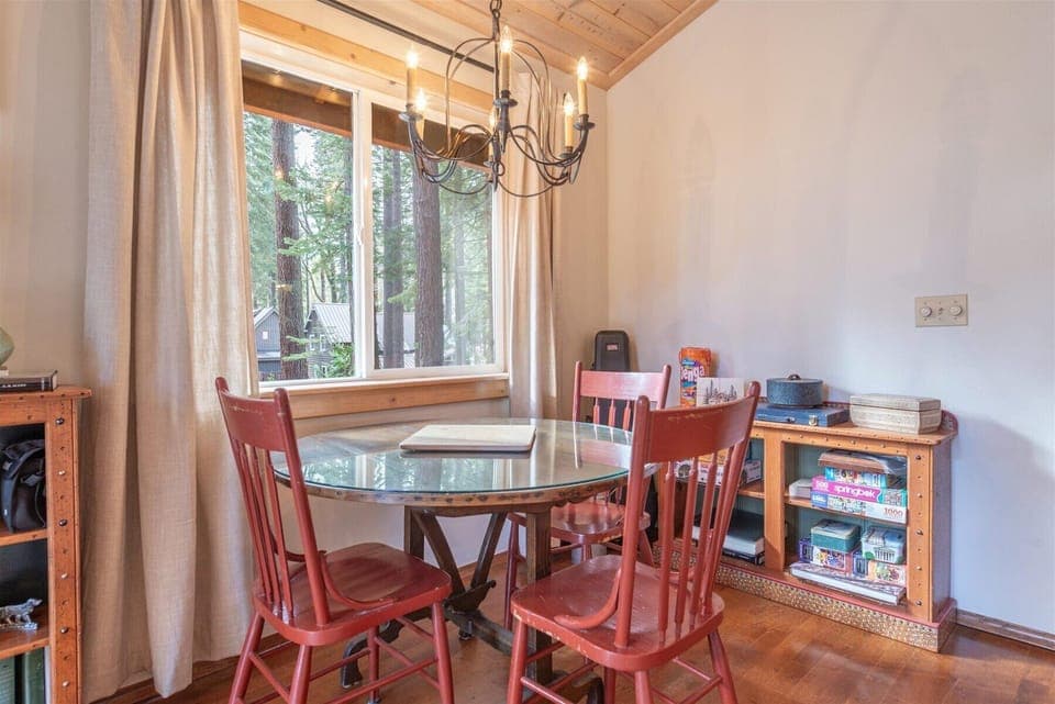 Gather around your cozy nook, lit by an elegant chandelier to light up fun-filled evenings ready for game night with the bookshelf stocked with boardgames.