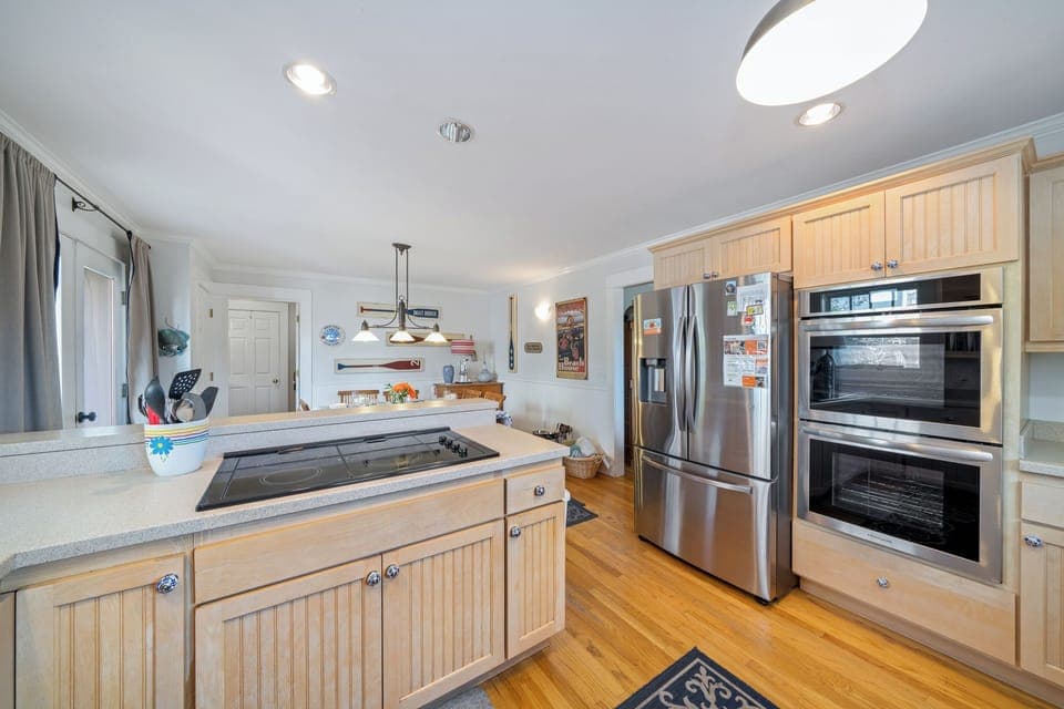 Fully equipped Kitchen with double oven, dishwasher, fridge and Jenn-Air stove open to the dining room