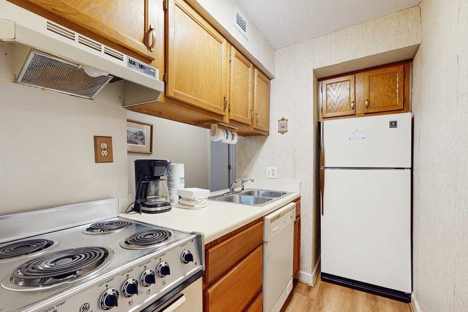 Charming kitchen awaits. And, whip up meals with ease in this fully equipped, inviting space!