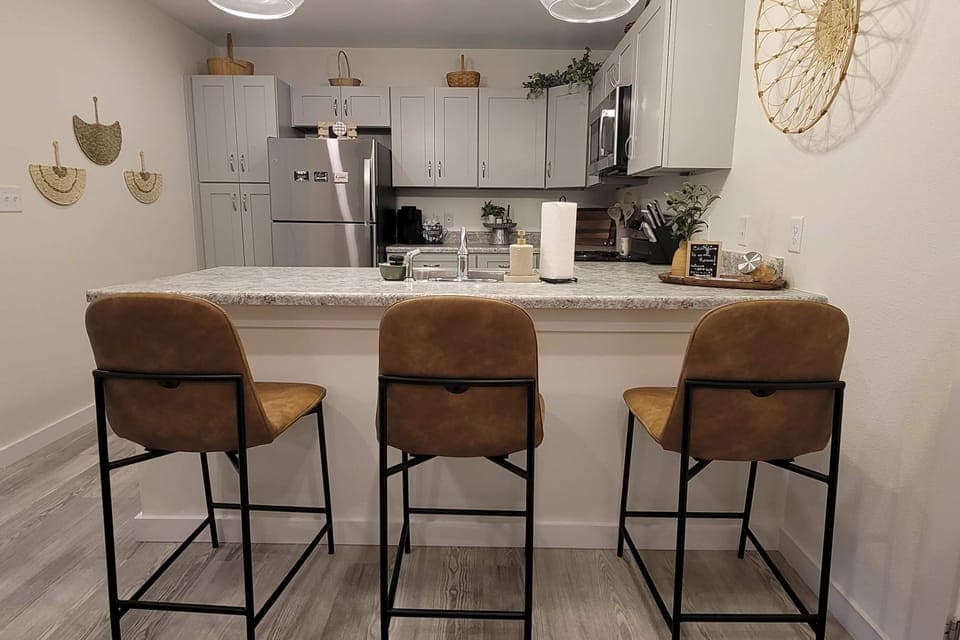 Stylish bar seating invites culinary adventures and casual gatherings. Enjoy!