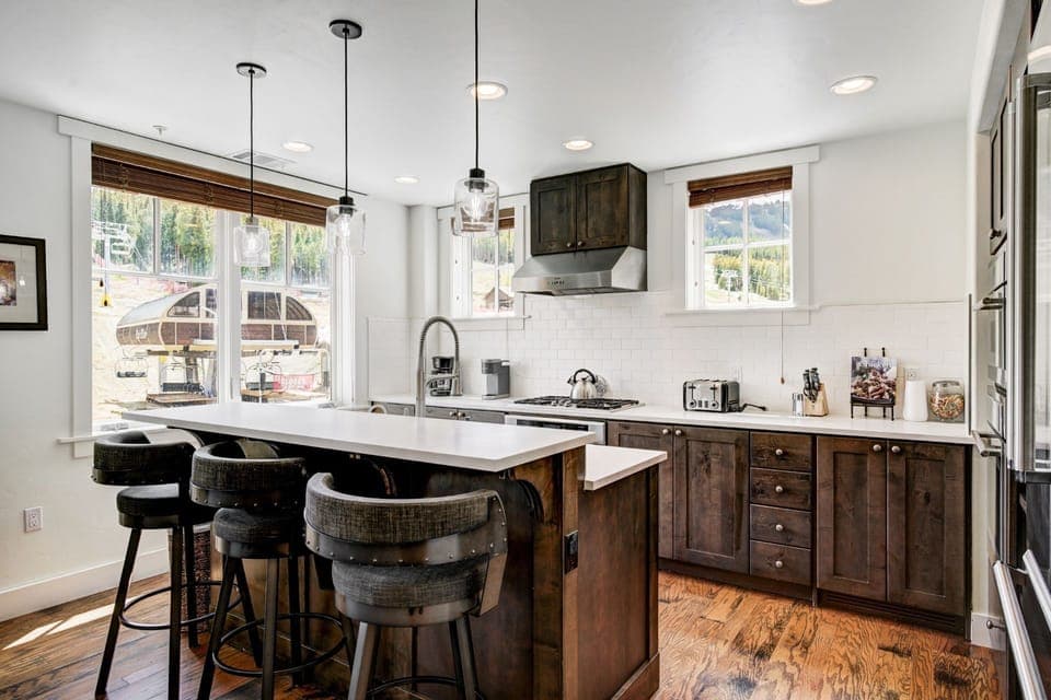 Modern kitchen nook with sleek countertops, dark wood accents, and bar seating for casual dining or morning coffee.