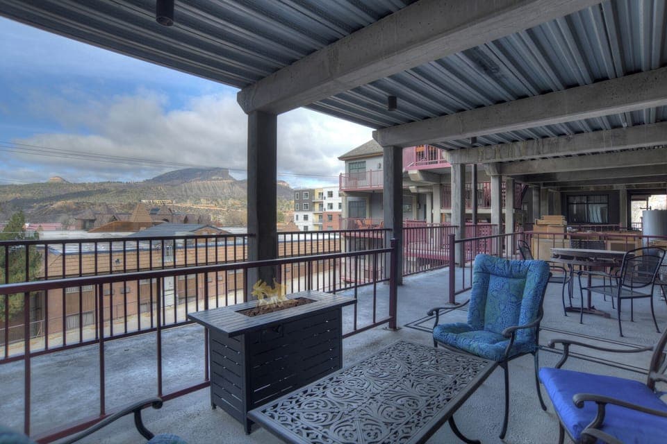 Covered outdoor space with seatting and gas firepit