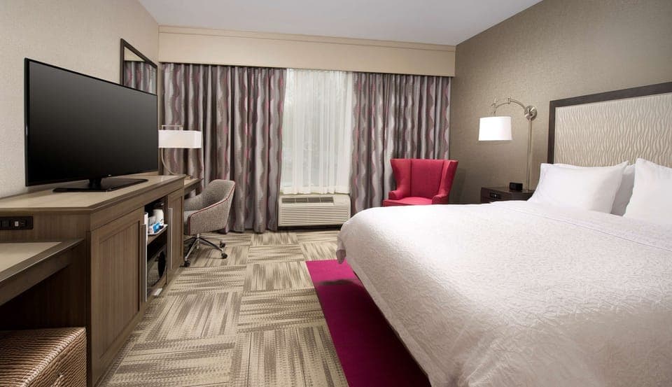 Premium bedding, desk, laptop workspace, blackout drapes