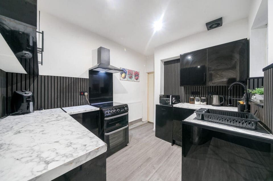 Sleek black kitchen with modern appliances